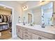 Modern main bathroom features double vanity, large mirror, walk-in closet and walk-in shower at 1021 Greatland Rd, Durham, NC 27703