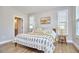 Bright main bedroom features large windows with blinds, hardwood floors, and neutral-toned decor at 1021 Greatland Rd, Durham, NC 27703