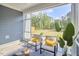 Covered outdoor porch with seating, a table, foliage, and an outdoor view at 1021 Greatland Rd, Durham, NC 27703