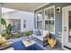 Covered outdoor porch with a couch, throw pillows, a table, and a cozy atmosphere at 1021 Greatland Rd, Durham, NC 27703