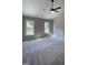 Comfortable bedroom featuring two bright windows, ceiling fan and neutral carpet at 103 Romaine Ct, Cary, NC 27513