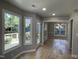 Bright dining room with hardwood floors, modern lighting, deck access and open to another room at 103 Romaine Ct, Cary, NC 27513