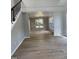 Open dining room with hardwood floors, large windows and a modern light fixture at 103 Romaine Ct, Cary, NC 27513