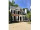 Charming two-story brick home with black shutters, well-maintained lawn, and paved driveway at 103 Romaine Ct, Cary, NC 27513