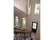 Bright open foyer with hardwood floors, natural light, staircase, and modern pendant lighting at 103 Romaine Ct, Cary, NC 27513