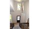 Bright open foyer with hardwood floors, natural light, staircase, and modern pendant lighting at 103 Romaine Ct, Cary, NC 27513