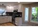 Kitchen features white cabinets, stainless steel appliances, and modern finishes at 103 Romaine Ct, Cary, NC 27513