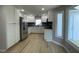 Bright kitchen features white cabinets, stainless steel appliances, and modern finishes at 103 Romaine Ct, Cary, NC 27513