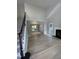 Living room with fireplace, hardwood floors, stairs, and open view into dining room with many windows at 103 Romaine Ct, Cary, NC 27513
