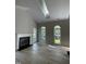 Bright living room with a fireplace and plenty of natural light from large windows and skylight at 103 Romaine Ct, Cary, NC 27513