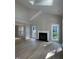 Bright living room with high ceilings, hardwood floors, and a cozy fireplace at 103 Romaine Ct, Cary, NC 27513