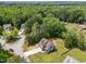 Aerial view of a home with lush trees, spacious yard, and surrounding neighborhood at 104 Anderson Park Dr, Wake Forest, NC 27596