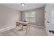 Cozy bedroom with a charming desk, chair, and natural light from the window at 104 Anderson Park Dr, Wake Forest, NC 27596