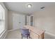 Inviting bedroom features a wooden desk and chair, with views to the hallway at 104 Anderson Park Dr, Wake Forest, NC 27596