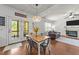 Bright dining area with access to the deck, stylish lighting, and a view into the inviting living room at 104 Anderson Park Dr, Wake Forest, NC 27596