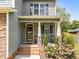 Cozy front porch with decorative columns, a seating area, and lovely landscaping at 104 Anderson Park Dr, Wake Forest, NC 27596