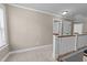 Second floor hallway features neutral paint with carpet and white wooden railing at 104 Anderson Park Dr, Wake Forest, NC 27596