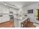 Kitchen with white cabinets, granite countertops, stainless steel appliances and lighting at 104 Anderson Park Dr, Wake Forest, NC 27596