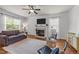 Bright and open living room with fireplace, ceiling fan, and stylish decor at 104 Anderson Park Dr, Wake Forest, NC 27596