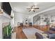 Open living room with fireplace, ceiling fan, stairs to the second floor, and easy access to kitchen at 104 Anderson Park Dr, Wake Forest, NC 27596