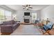Bright and open living room with fireplace, ceiling fan, and hardwood floors at 104 Anderson Park Dr, Wake Forest, NC 27596