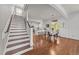 Spacious open floor plan seamlessly connects the staircase, kitchen, and dining area, perfect for modern living at 104 Anderson Park Dr, Wake Forest, NC 27596