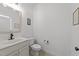 Half bathroom features white vanity, neutral paint, and luxury mirror detail at 104 Anderson Park Dr, Wake Forest, NC 27596