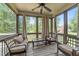 Relaxing screened porch with seating, ceiling fan, and view of the outdoors at 104 Anderson Park Dr, Wake Forest, NC 27596