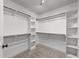 Spacious walk-in closet offers ample storage with shelving and wooden hanging rods at 104 Anderson Park Dr, Wake Forest, NC 27596