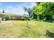 Large backyard featuring a combination of lawn, mature trees, and a privacy fence at 1041 Davis Dr, Apex, NC 27523