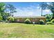 Expansive backyard with a well-maintained lawn and mature trees creating a serene setting at 1041 Davis Dr, Apex, NC 27523