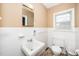 Bright bathroom with white tile, modern fixtures, and a window at 1041 Davis Dr, Apex, NC 27523