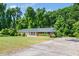 Charming single-story brick home with a well-maintained lawn and paved driveway at 1041 Davis Dr, Apex, NC 27523