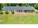 Charming brick ranch-style home with a well-manicured lawn and mature trees at 1041 Davis Dr, Apex, NC 27523