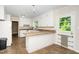 Cozy kitchen featuring white cabinets, a breakfast bar, and a door to the outside at 1041 Davis Dr, Apex, NC 27523