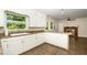 Open concept kitchen with white cabinetry, counter space, and transition to living room at 1041 Davis Dr, Apex, NC 27523