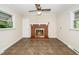 Cozy living room featuring a brick fireplace, ceiling fan, and tiled flooring at 1041 Davis Dr, Apex, NC 27523