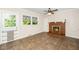 Cozy room with brick fireplace, ceiling fan, tiled flooring and ample windows at 1041 Davis Dr, Apex, NC 27523