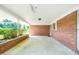 View of the covered patio area with brick walls and concrete floor at 1041 Davis Dr, Apex, NC 27523