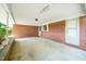 View of the covered patio area with brick walls and concrete floor at 1041 Davis Dr, Apex, NC 27523