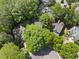 Aerial view showcasing a neighborhood surrounded by mature trees at 105 Sundew Ln, Cary, NC 27518