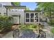 An inviting backyard with a screened porch and a view of the surrounding garden at 105 Sundew Ln, Cary, NC 27518