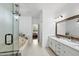 Bright bathroom with double marble vanity, tiled floors, glass shower, and soaking tub at 105 Sundew Ln, Cary, NC 27518