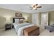 Comfortable bedroom with a ceiling fan, light walls, a window and a side table with a lamp at 105 Sundew Ln, Cary, NC 27518