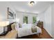 Inviting bedroom featuring hardwood floors, two windows, and tasteful decor at 105 Sundew Ln, Cary, NC 27518