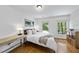 Cozy bedroom with hardwood floors, two windows, and stylish decor at 105 Sundew Ln, Cary, NC 27518