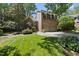 Attractive brick home displays lush landscaping and a spacious front lawn, creating a welcoming entrance at 105 Sundew Ln, Cary, NC 27518