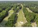 Stunning aerial view of the meticulously maintained golf course with sand traps and mature trees at 105 Sundew Ln, Cary, NC 27518