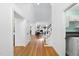 Hallway featuring hardwood floors and an open view of the living room with a fireplace at 105 Sundew Ln, Cary, NC 27518