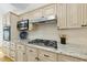 Close-up of a modern kitchen counter, gas range and stainless appliances at 105 Sundew Ln, Cary, NC 27518